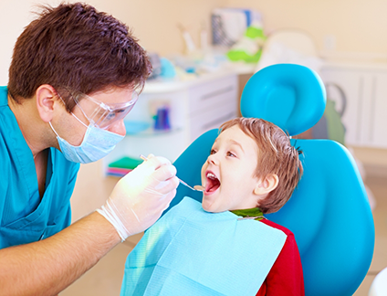 Young boy in dental chair receiving a dental exam