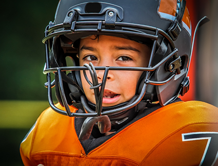 Young boy wearing a football helmet