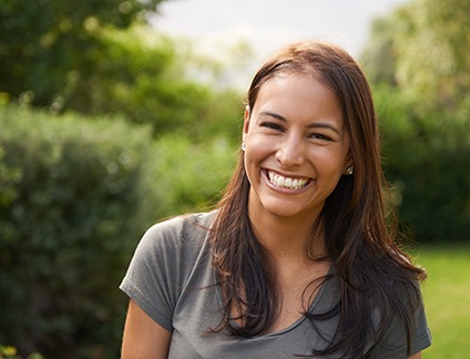 Young woman smiling outside