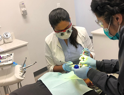 Doctor Shah and dental assistant performing a procedure on a patient