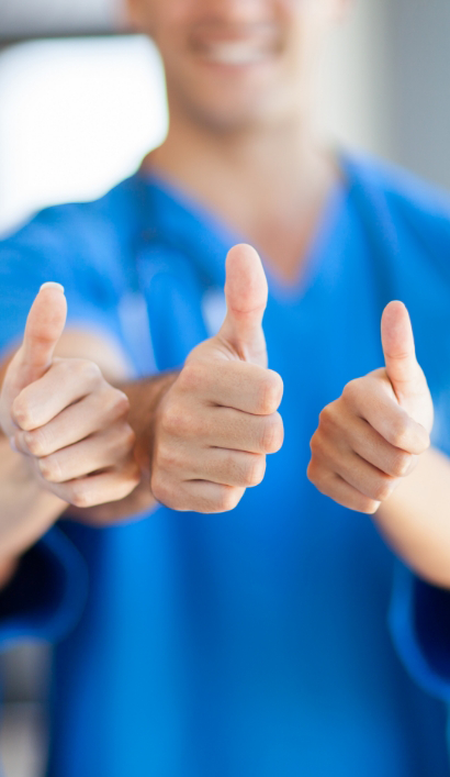 Three smiling Peabody dentists giving thumbs up