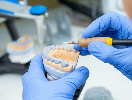 Dental ceramist designing a denture