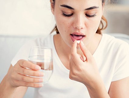 Woman taking a pill