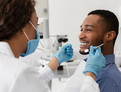 Man smiling at his dentist during a dental checkup