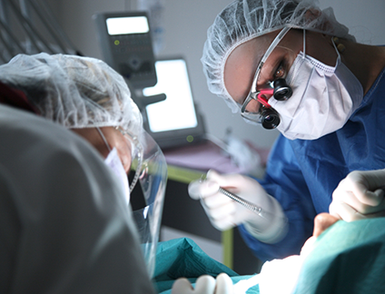 Dentist and assistant performing a procedure on a patient