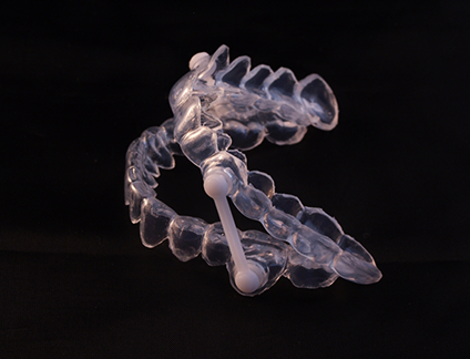 Clear oral appliance against black background